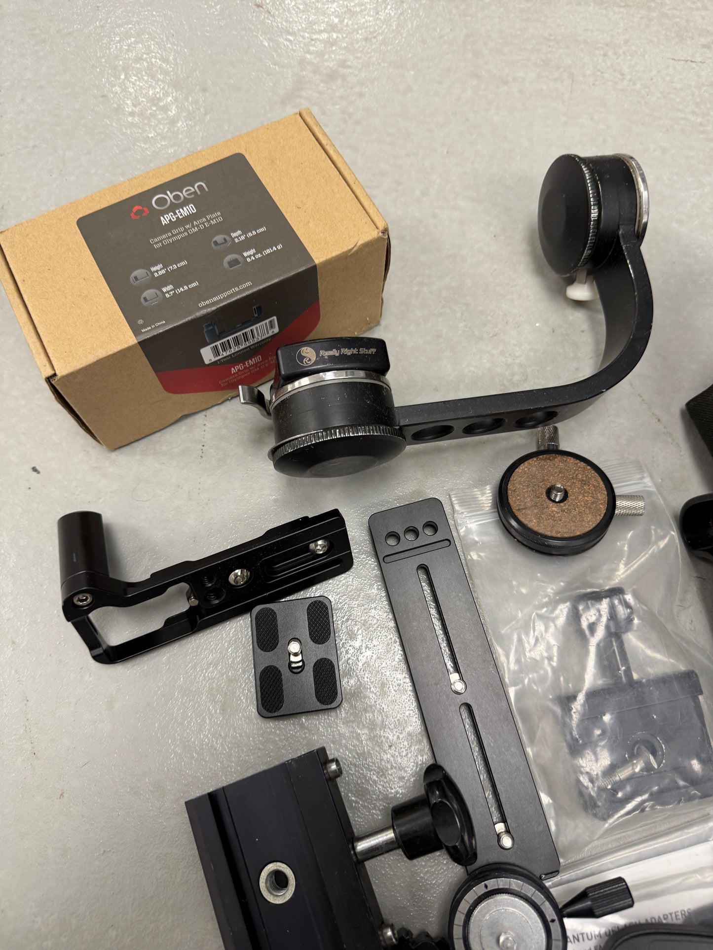 Lot of camera plates, tripod accessories and clamps really right stuff, Oben, Wefoto, etc