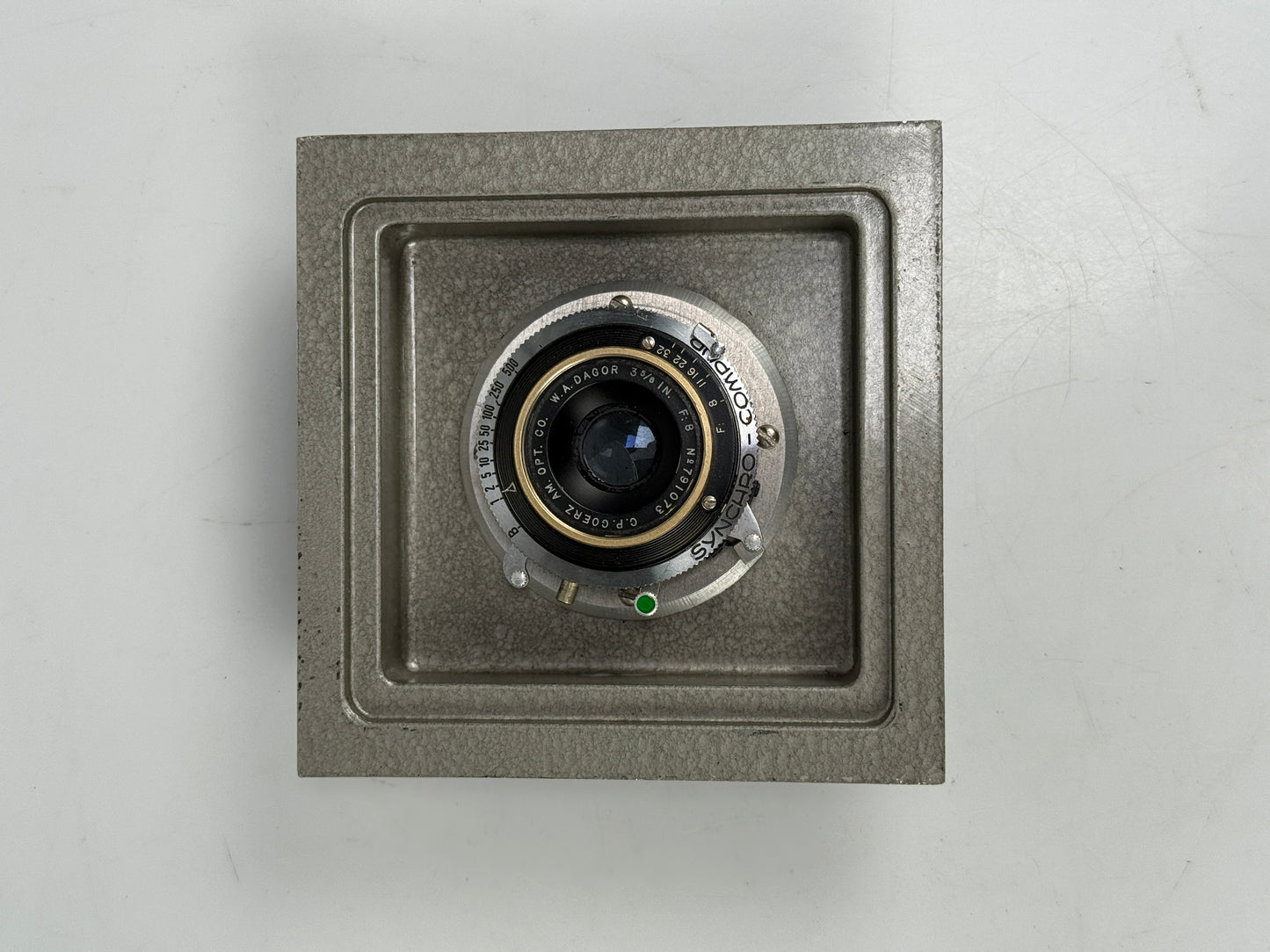 C P Goerz AM Opt Co 3 5/8" WA Dagor f8 Camera Lens gold ring in board