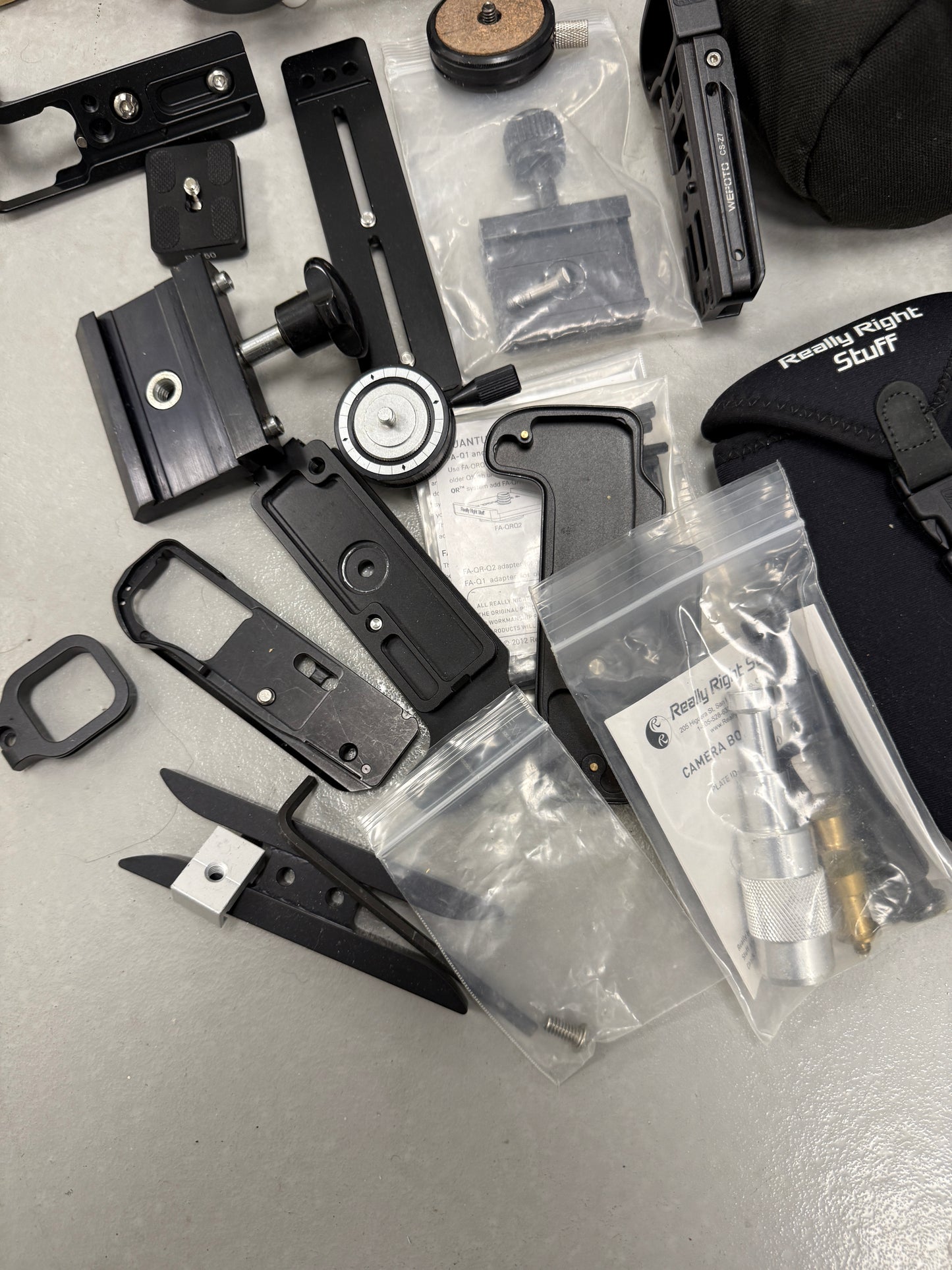 Lot of camera plates, tripod accessories and clamps really right stuff, Oben, Wefoto, etc
