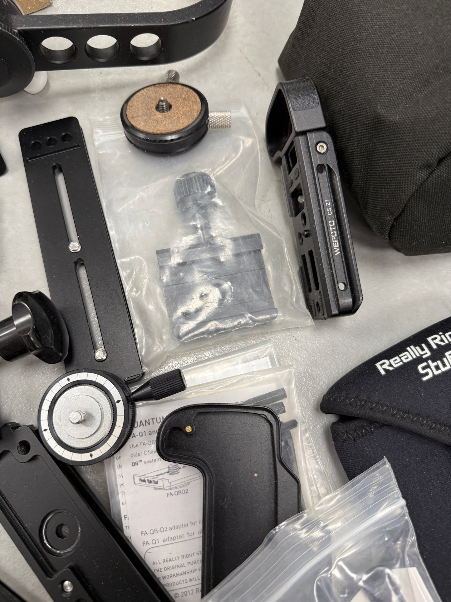 Lot of camera plates, tripod accessories and clamps really right stuff, Oben, Wefoto, etc