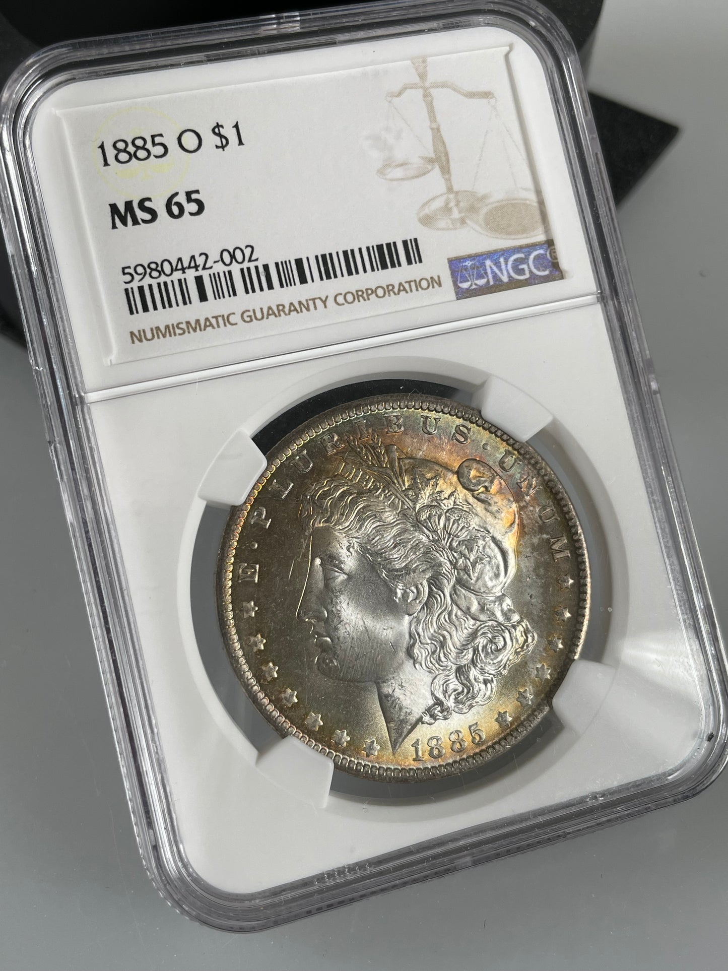 1885-O Morgan Dollar NGC MS65 Rainbow Toned